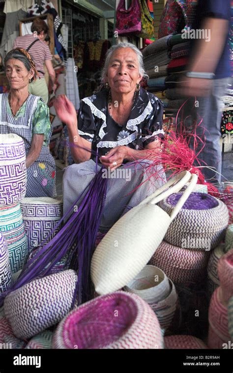 A Local Woman Weaving Baskets And Bags In The Market In San Cristobel