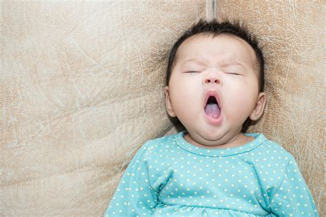 Portrait Of A Yawning Baby Girl On A Leather Background Cloudmom