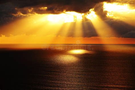 Golden Sunlight Through Dark Clouds Over Ocean Aerial