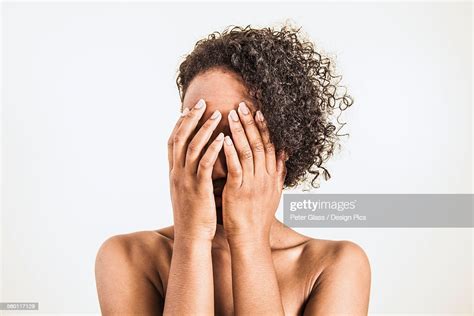 A Young Woman Covering Her Face With Her Hands Photo Getty Images
