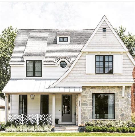 Charming White House With Stone And Black Window Frames House