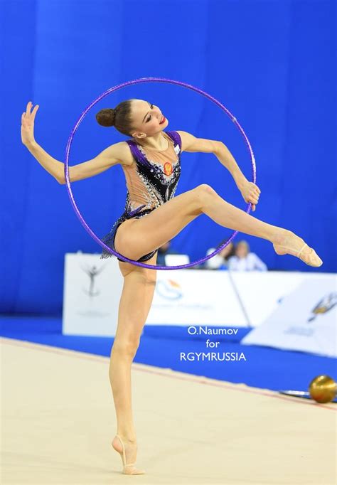 A Woman Is Doing Tricks With A Hoop