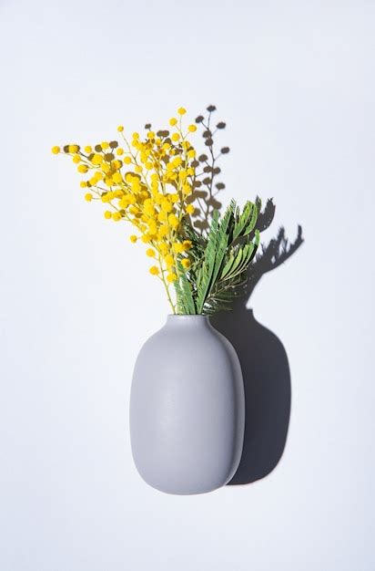 Premium Photo A Bouquet Of Yellow Mimosa Flowers Stands In A Ceramic