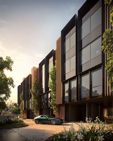 A Car Is Parked In Front Of Some Tall Buildings With Windows On Each