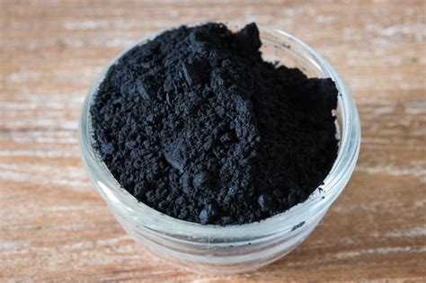 Premium Photo Close Up Of Activated Black Charcoal Powder In A Glass