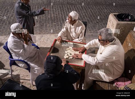 jeddah saudi arabia january 16 2020 old muslim men playing dominoes at night in the