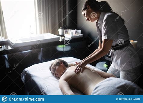 Beautiful Young Woman Relaxing With Massage Treatment At Beauty Spa