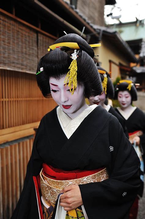 Two Geisha Women Dressed In Traditional Japanese Costumes