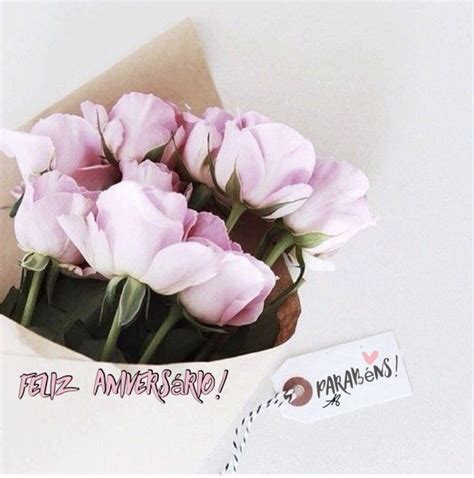 There Is A Bouquet Of Pink Roses In A Paper Bag With A Tag On It