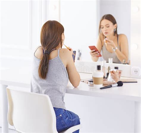 Amazing Young Woman Doing Her Makeup In Front Of Mirror Portrait Of