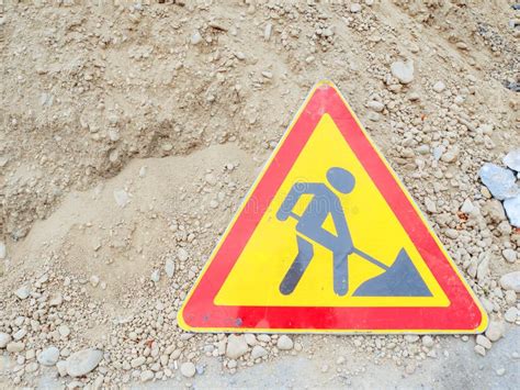 Triangular Red Yellow Road Sign With A Picture Of A Digging Man Stand