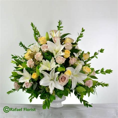 Memorial Flower Arrangement Of White Lilies Yellow And