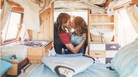 Happy Man And Woman Kissing Inside Vintage Minivan Travel Couple