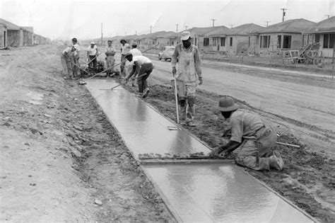 Several Men Are Working On The Construction Of A Sidewalk In An Old