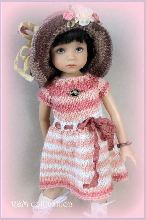 A Doll Wearing A Knitted Dress And Hat