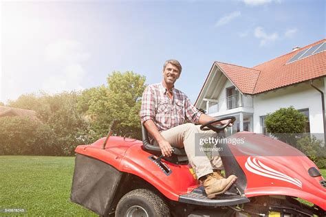 Man On Riding Lawn Mower In Garden High Res Stock Photo Getty Images