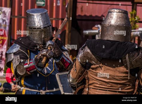 Medieval Knights Fighting With Armor Swords And Shields In Festival