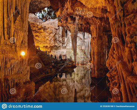 Tourists Cross The Spectacular Neptune Caves In Sardinia Stock Photo