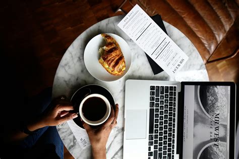 Macbook Pro And A Cup Of Coffee On Table · Free Stock Photo