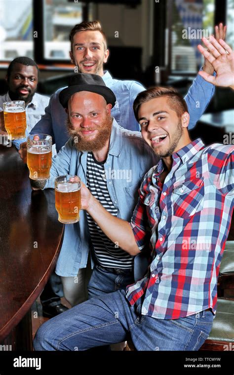 Young Men Drinking Beer In Pub Stock Photo Alamy