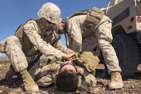 Navy Petty Officer 2nd Class Marlon Esmade Left Provides Medical