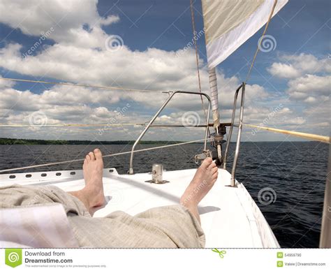 Bare Foot Of A Man Who Is Lying On The Deck Of The Yacht Stock Photo