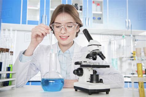 Young Female Scientist Making Chemical Experiment In Laboratory Stock