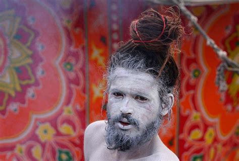 An Ash Smeared Hindu Sadhu Or Holy Man Poses Beside A Tent In Allahabad