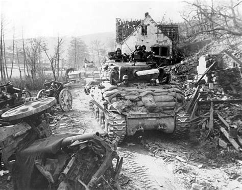 M4s Of The 7th Us Armys 14th Armored Division Roll Past Wrecked German