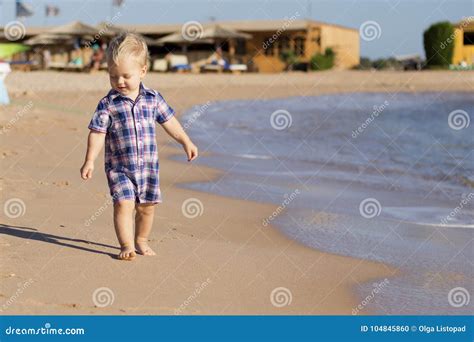 Small Baby Boy Walking The Seaside Oncept For Travel Ad Stock Photo