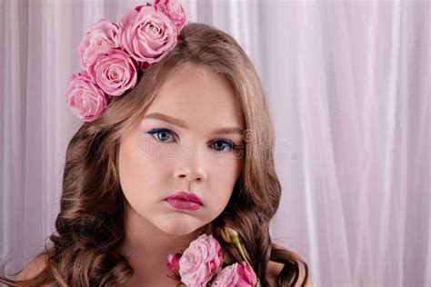 Teenage Girl With Pink Roses In Her Hair On Pink Silk Background