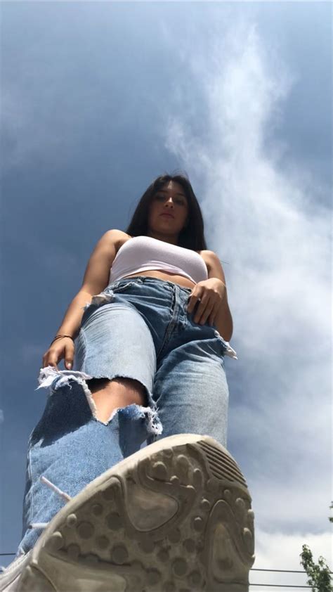 A Woman Sitting On Top Of A Pair Of Jeans