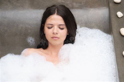 a real relax for a modern girl beautiful brunette takes a bath with foam stock image image of