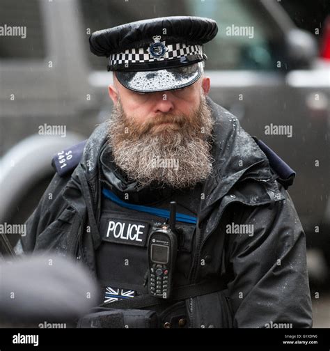 An Armed British Police Officer On Duty In Downing Street With A Full
