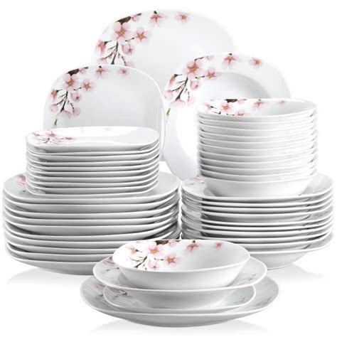 A Stack Of White Plates With Pink Flowers On Them
