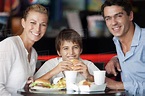 Family eating together in fast food restaurant, portrait - Stock Photo ...