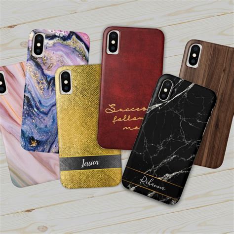 Four Iphone Cases In Different Colors And Designs On A Wooden Surface