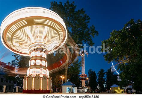 Rotating Carousel Merry Go Round Summer Evening In City Amusement Park