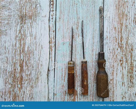 Antique Screwdrivers With Wooden Handle Isolated On The Wooden Table