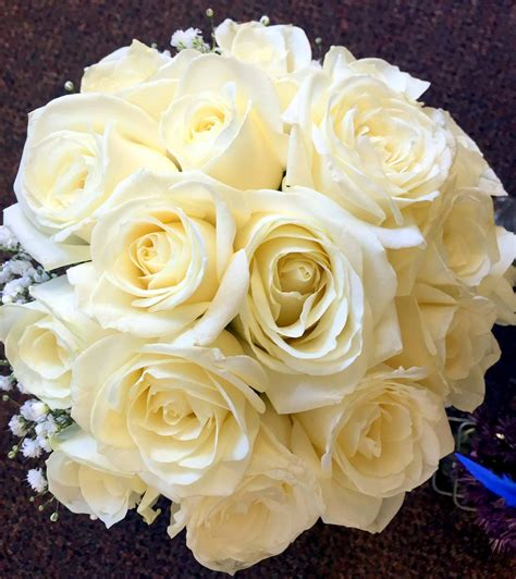 A Compact Hand Tied Of Ivory Avalanche Roses In A Nest Of Gypsophilia