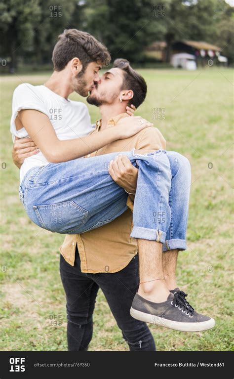 Kissing Young Gay Couple In A Park Stock Photo Offset