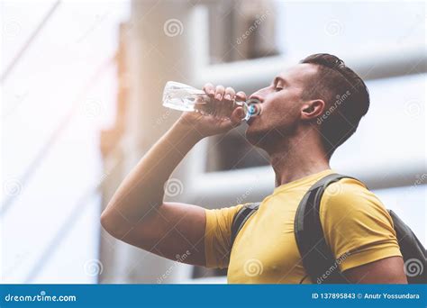 Yellow Sporty Guy Drinking Water In Hot Day Outdoor Stock Image Image