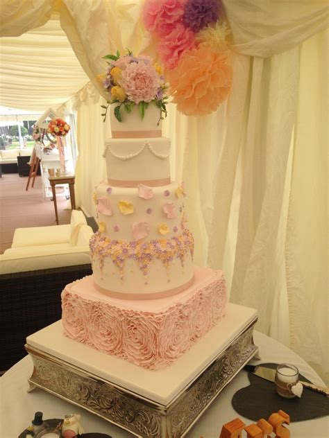 Spread 1/4 cup raspberry filling over top of cake inside border. Pretty Pastel wedding cake - Mel's Amazing Cakes