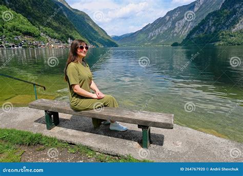 Woman Sit In Bench Over Austrian Alps Lake In Hallstatt Salzkammergut