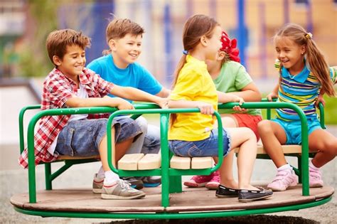 Kids Playing And Laughing With The Carousel Photo Free Download