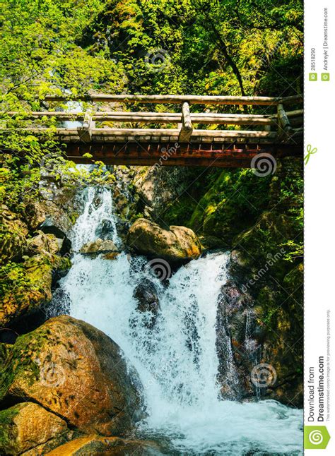 Wooden Bridge Over Waterfalls In The Mountains Stock Photo Image Of