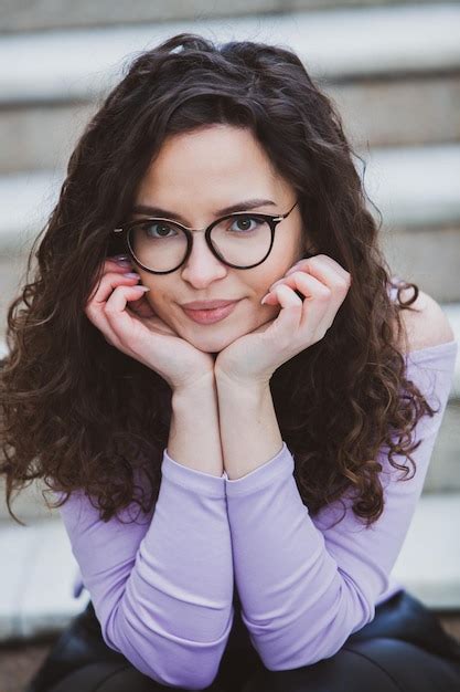 Premium Photo A Girl With Glasses On Her Face Sits On Steps