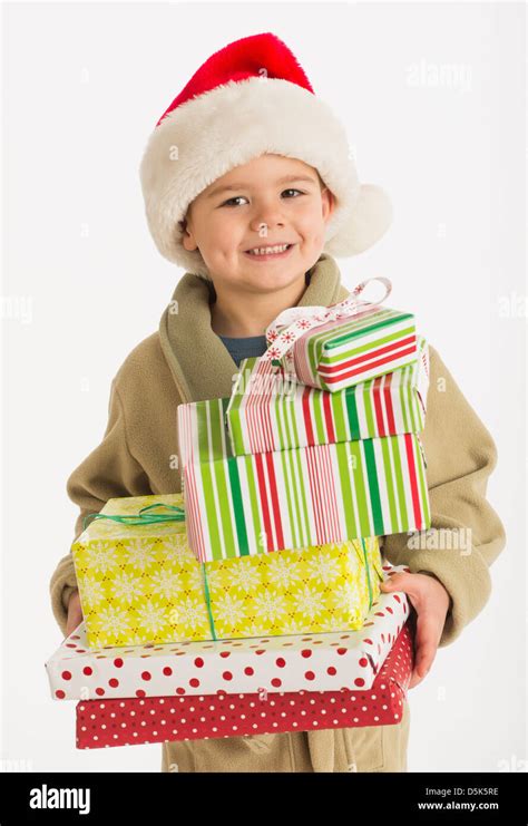 Portrait Of Boy 4 5 Carrying Christmas Presents Stock Photo Alamy