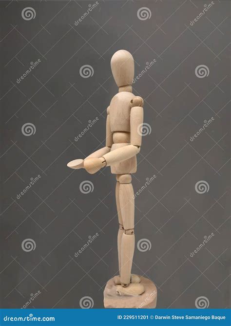 Wooden Human Body Figure Posing In Profile In A Philosophical Position