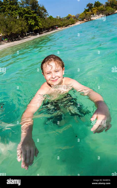 Boy Enjoys Swimming In The Ocean Stock Photo Alamy